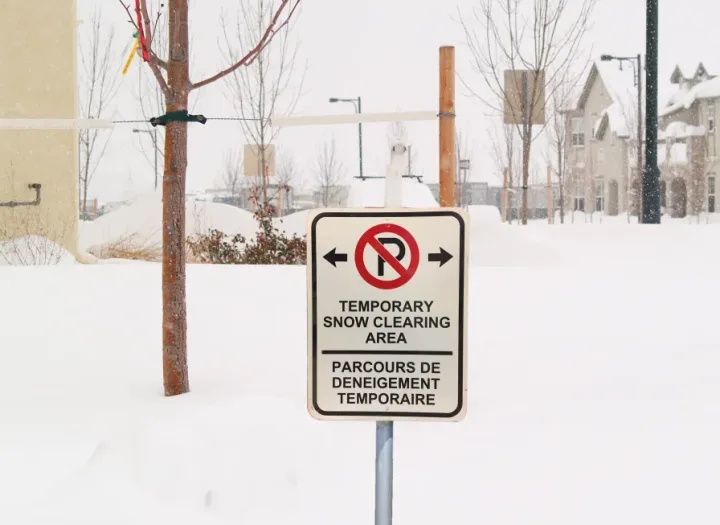 Temporary no-parking sign on a snow-covered Moncton street